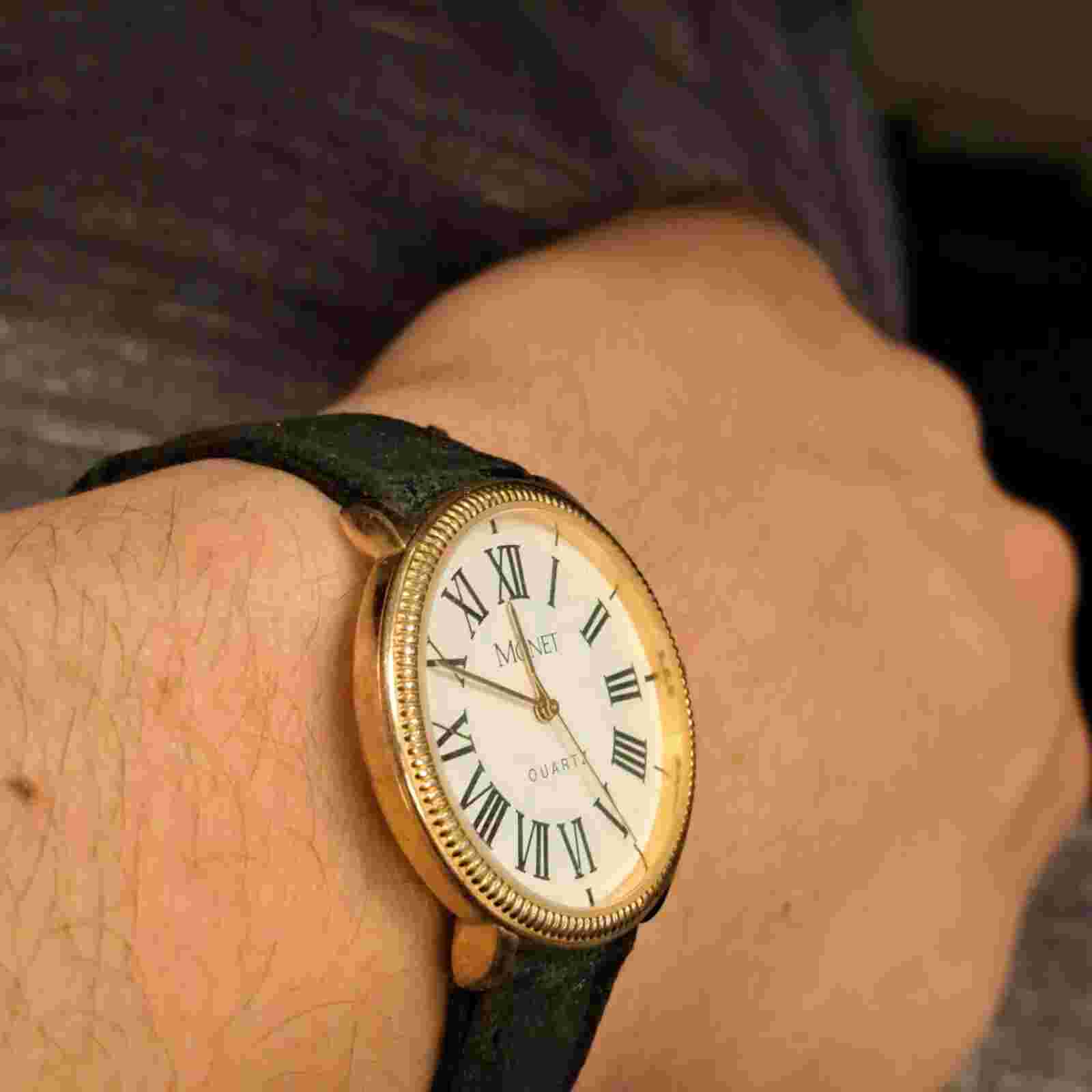 Monet Unisex Gold Tone Roman Numeral Quartz Black Buckle Band Analog Watch