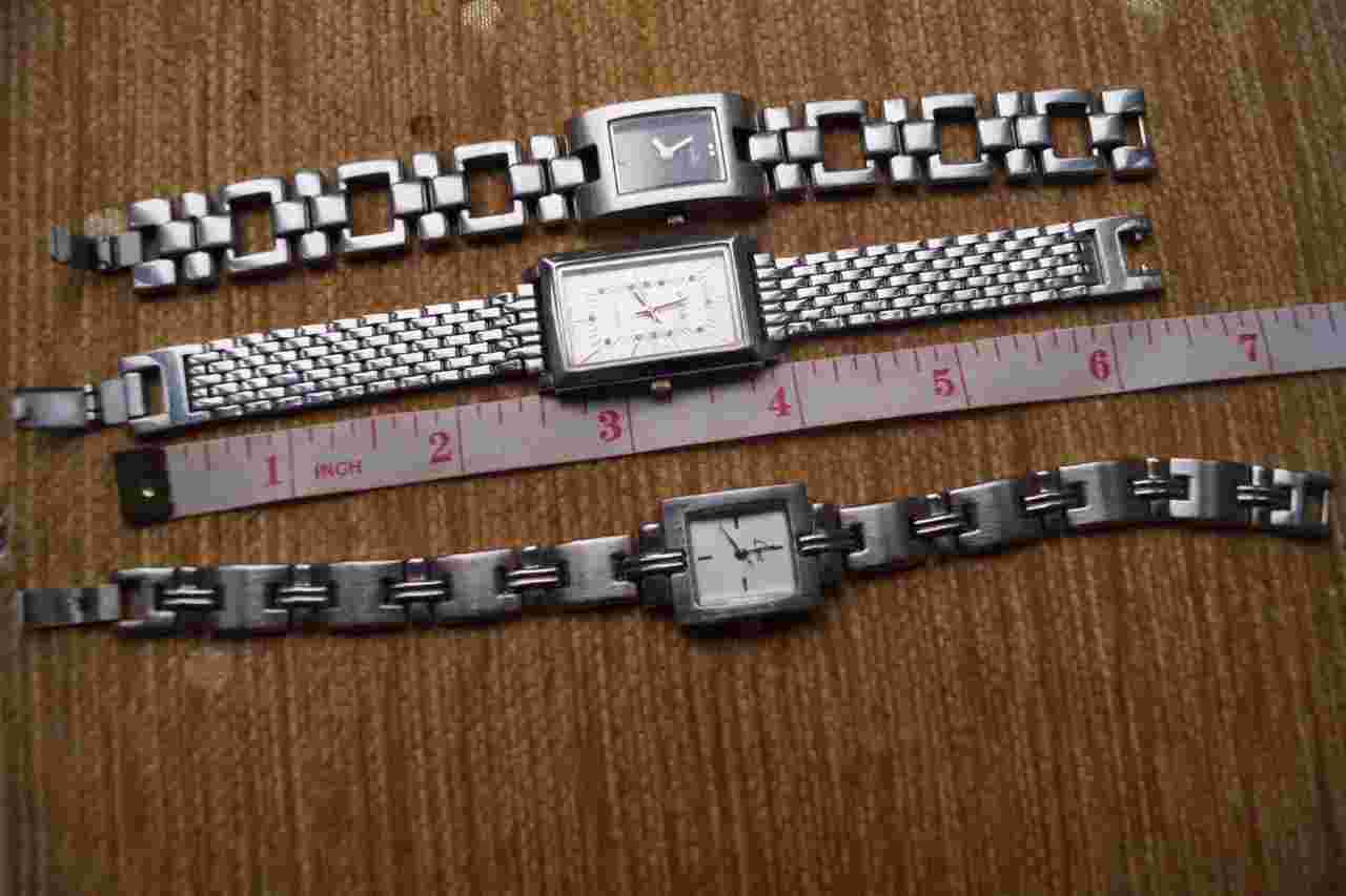 THREE  LADIES SILVER  TONE WATCHES WITH BRACELETS
