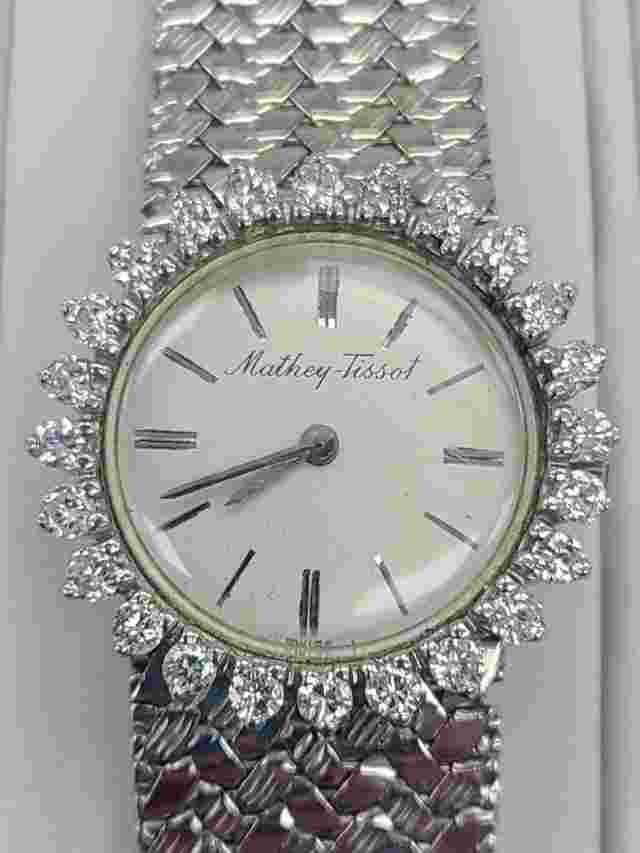 14 karat woman's vintage mathey tissot watch with diamond bezel and solid band