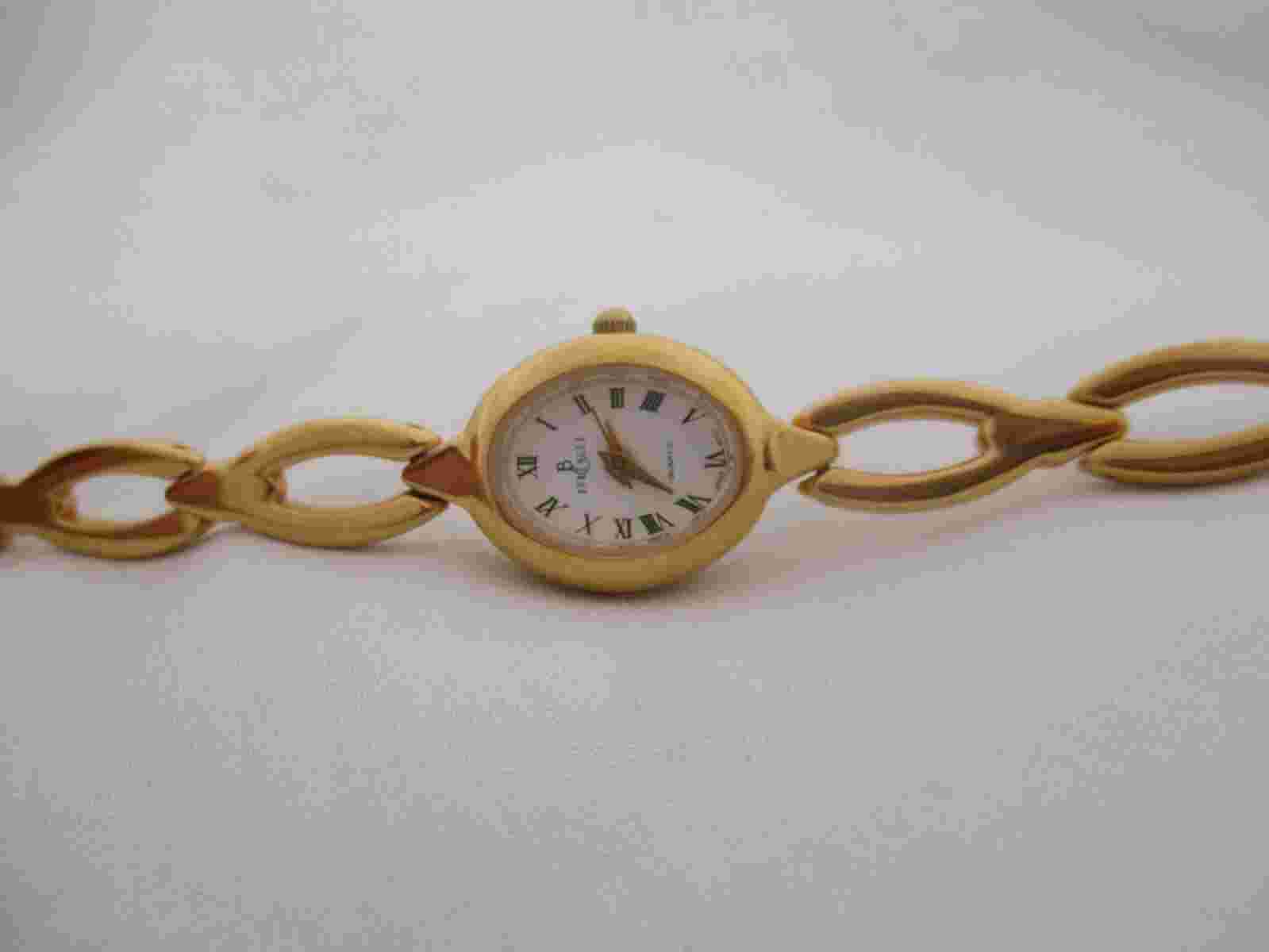 Berenger Wristwatch Gold Tone Band Oval Shaped White Face Roman Numerals