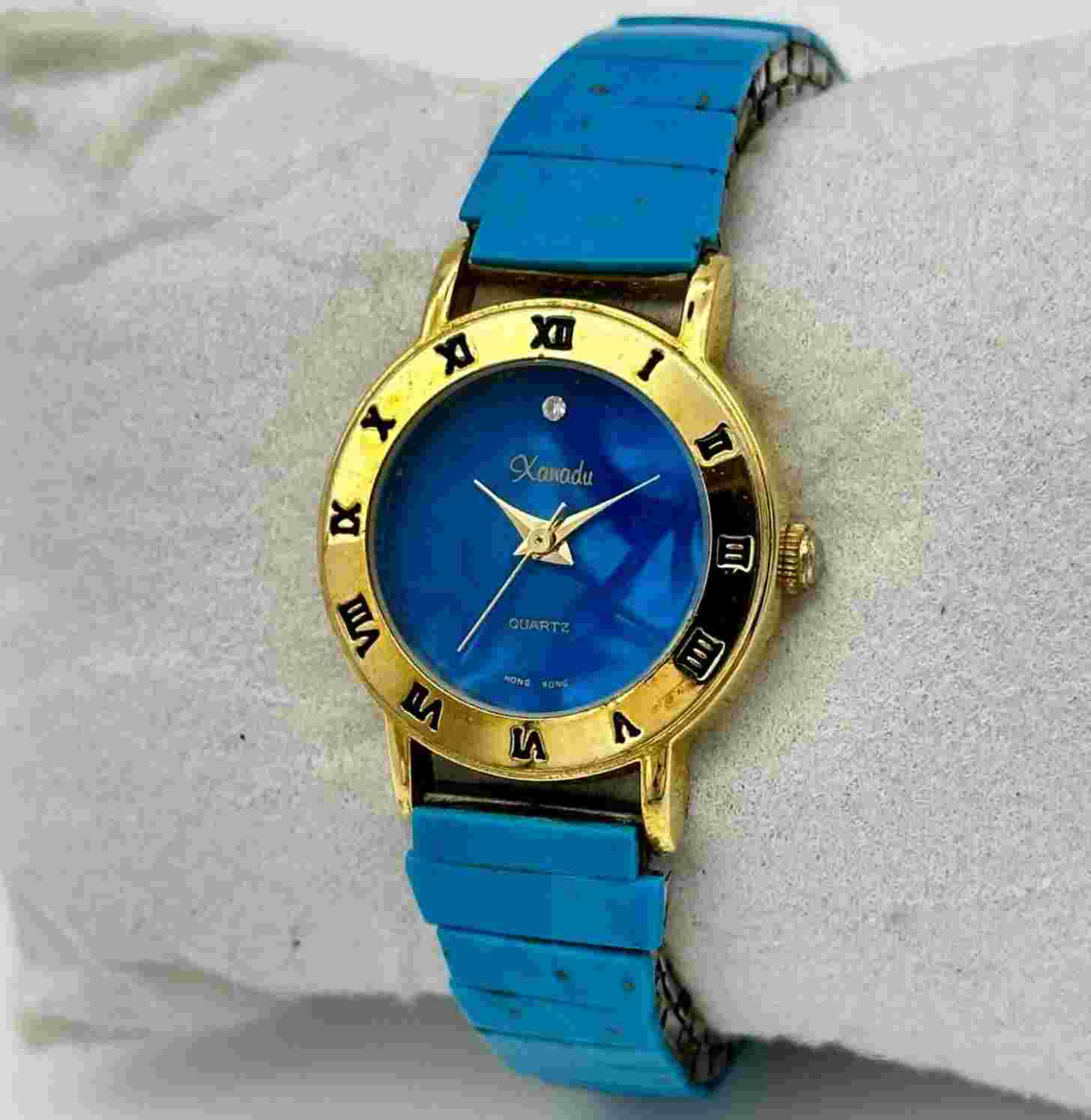 Ladies XANADU Blue & Gold Tone Flex Bracelet Watch, Blue Stone Top Caps, Running
