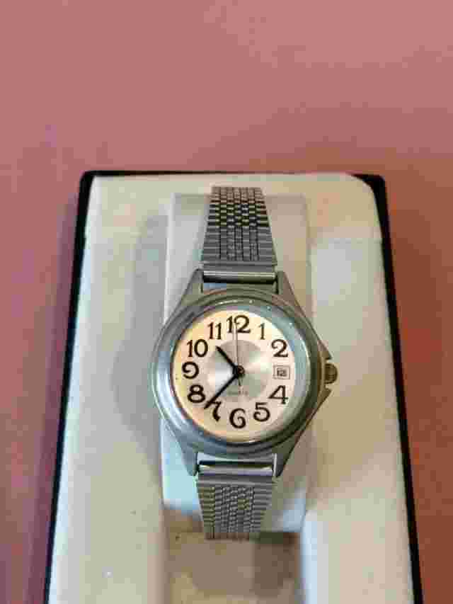 stainless steel fashion watch, s/s straps-bezel-and case.Runs and keeps time.