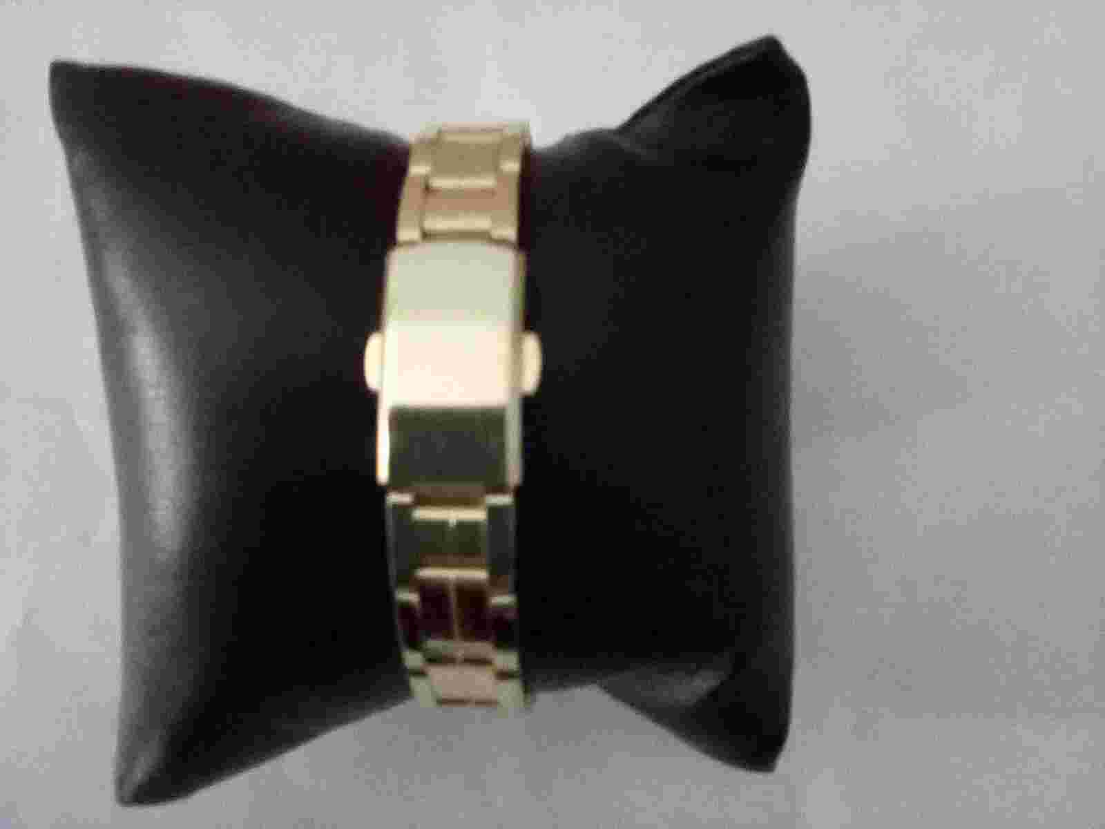 Milano gold watch with gold band. Measures 1.0" diameter.