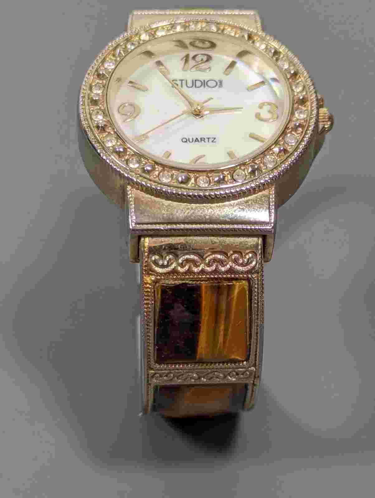 Studio MOP Dial Crystal Accent Tigers Eye Cabochon Gold Tone Hinge Band Watch