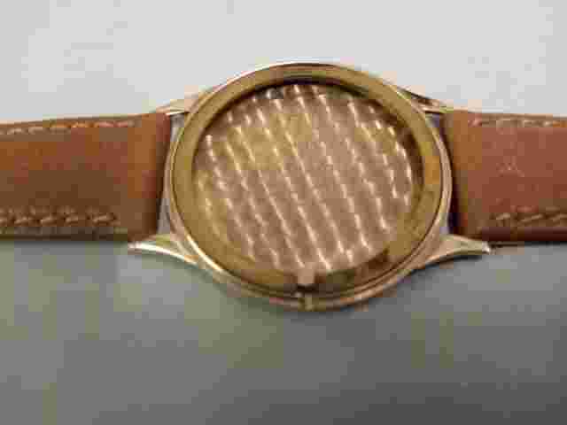 Gent's Accurist 9 carat gold mechanical strap watch on a leather strap.