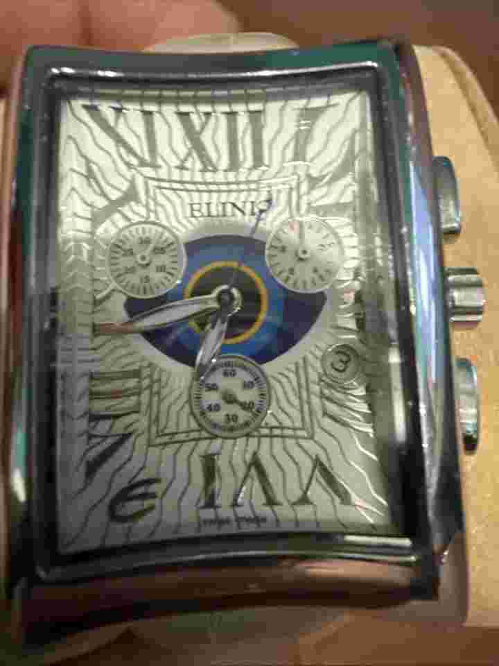 Stainless Steel Watch:  by Elini Nazar; Lucky Eye, White Leather band