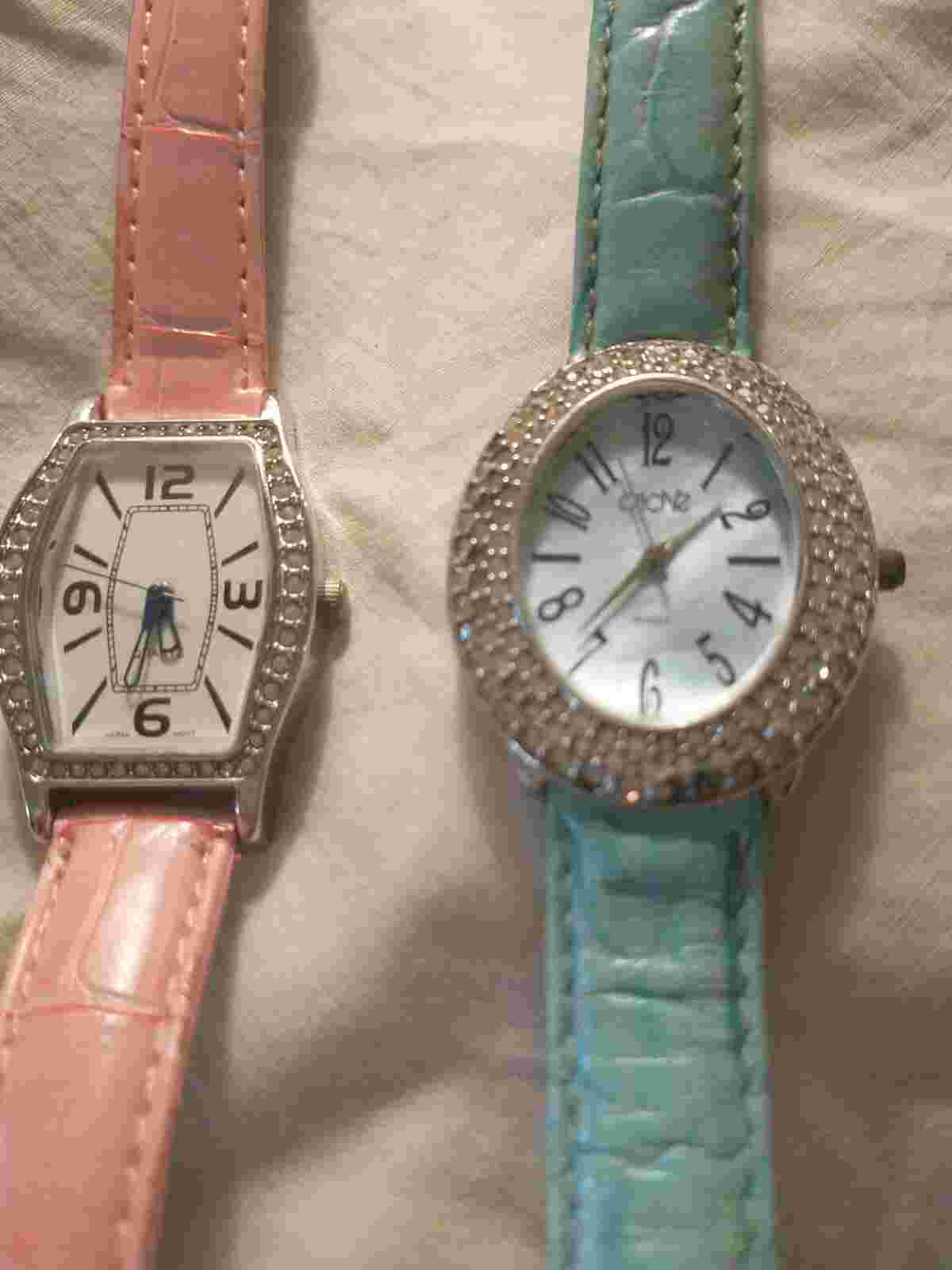 2 studded face lady's watches.  Turquoise & pink bands.  CACHE