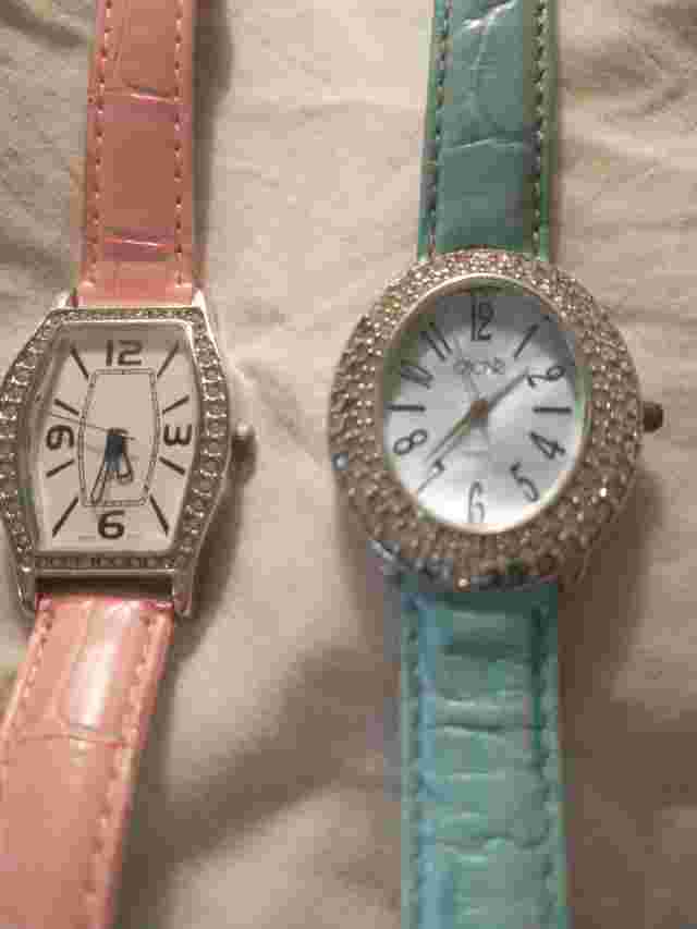 2 studded face lady's watches.  Turquoise & pink bands.  CACHE