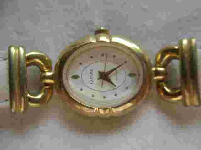Carriage Analog Wristwatch White Buckle Band Oval Shaped Face Gold Tone