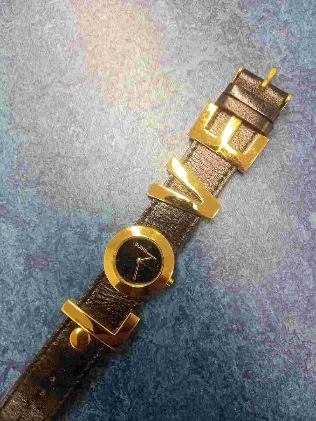 BCBG Womens LOVE Watch. Gold tone Large Letters, Black Leather Band. No Battery
