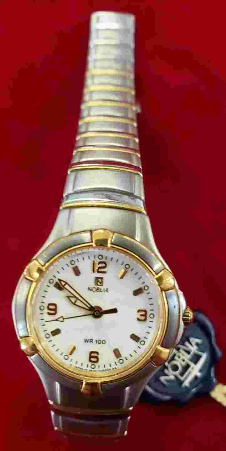 Noblia stainless steel gold and silver colored watch with box, tags, and booklet