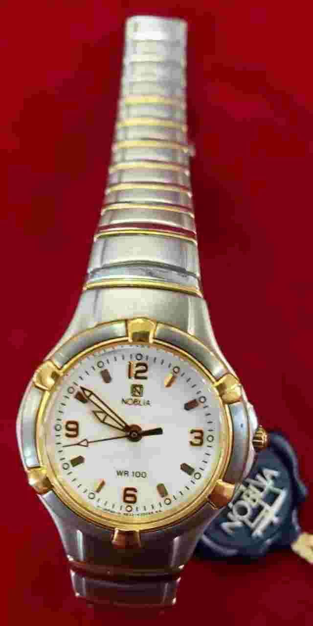 Noblia stainless steel gold and silver colored watch with box, tags, and booklet