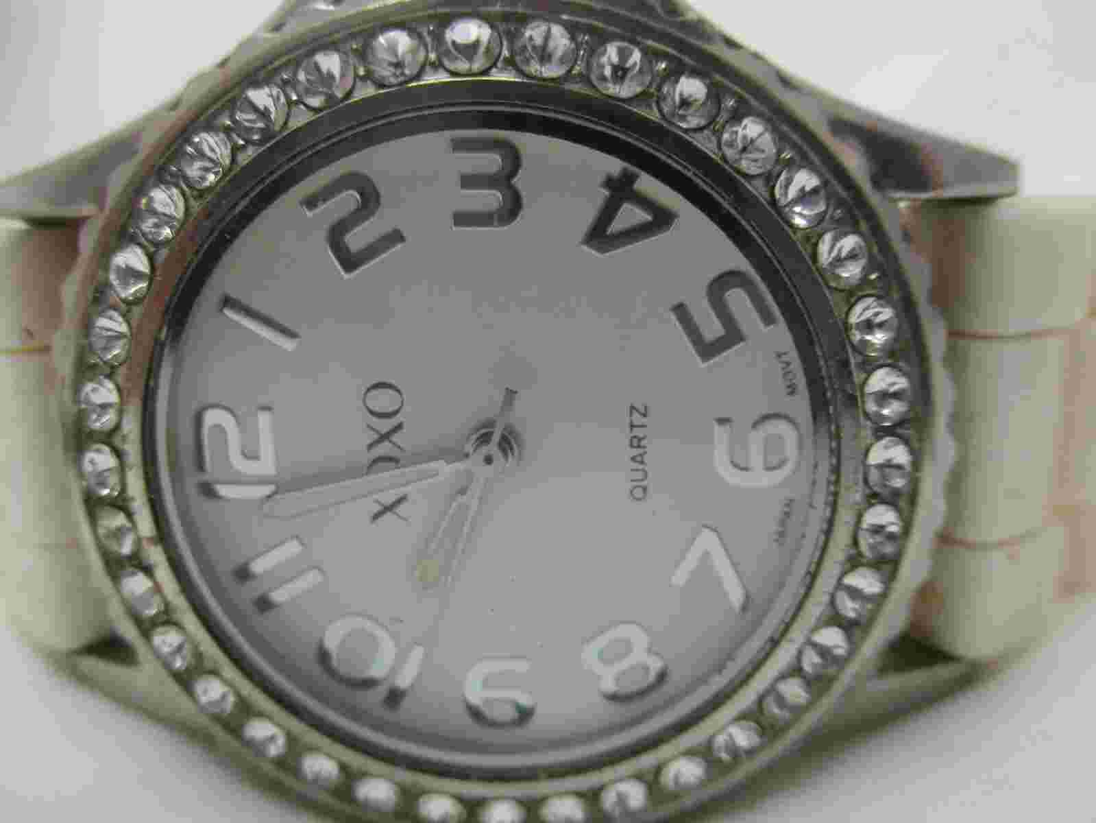 Xoxo Analog Wristwatch Round Face Silver Tone White Buckle Band Rhinestones