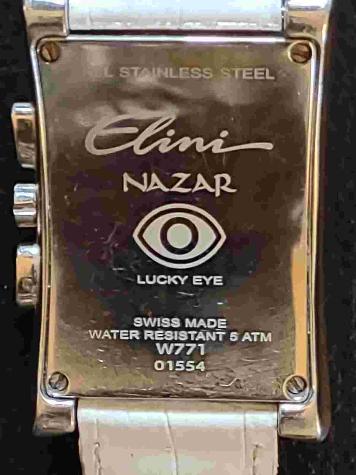 Stainless Steel Watch:  by Elini Nazar; Lucky Eye, White Leather band