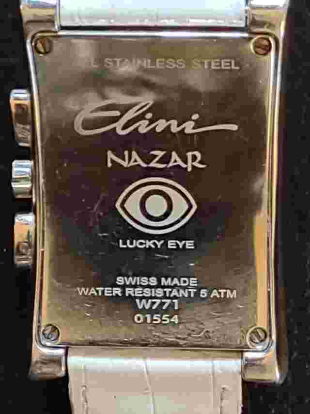 Stainless Steel Watch:  by Elini Nazar; Lucky Eye, White Leather band