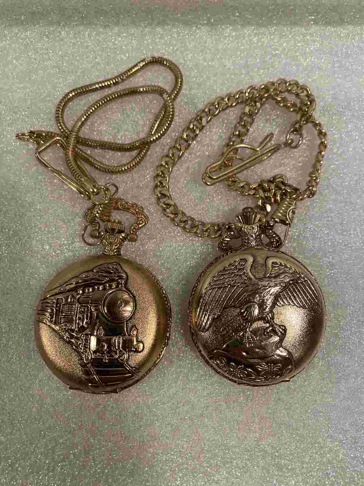 (2) Pocket Watches- Capezio Quartz (Golden Eagle) & Train Gold Tone. Chains.