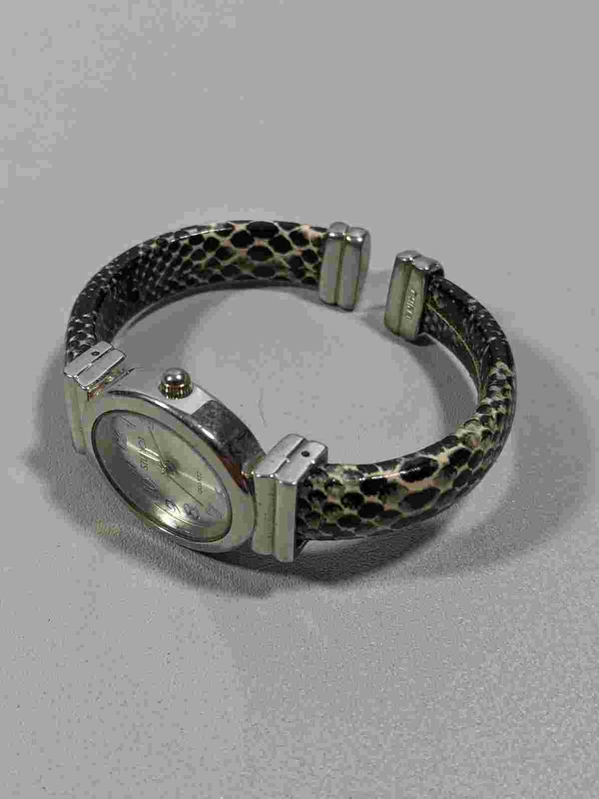 Studio Silver Tone Oval Case 24.8 mm Open Cuff Reptile Pattern Style Band Watch