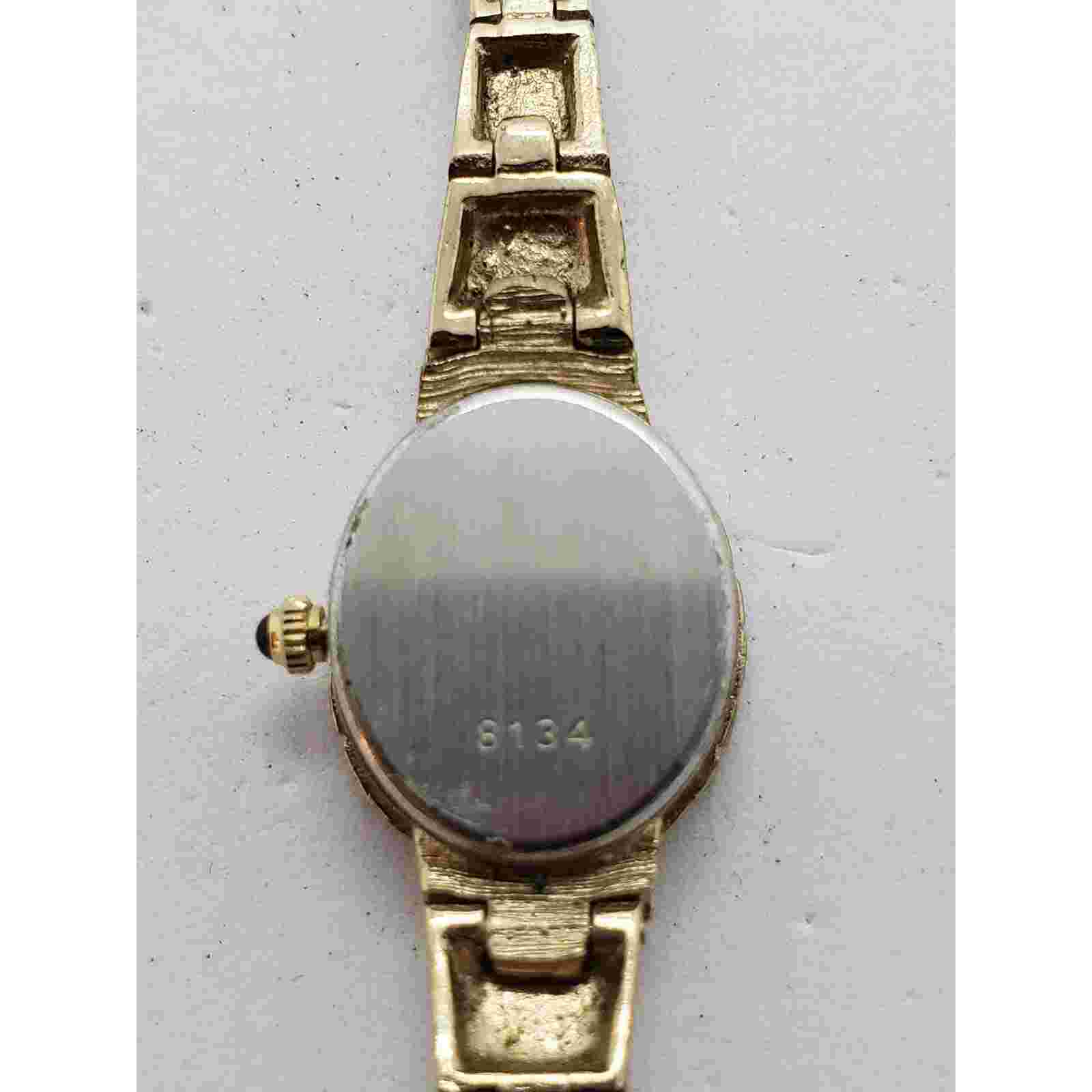 Geneva women's dress watch 9134. Gold face with gold accents. Sold as is