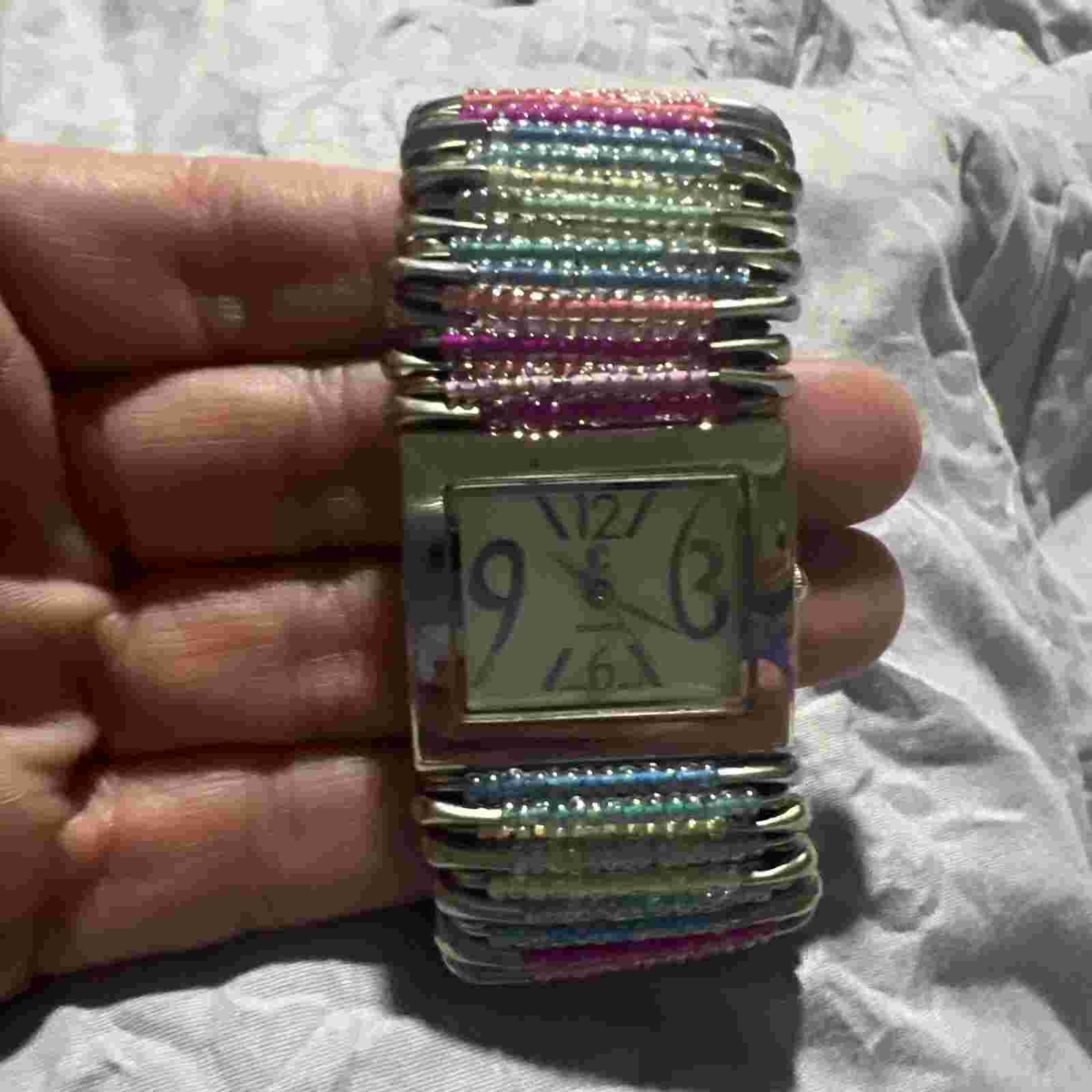 Ladies Multi Colored Elastic Safety Pin Watch, needs a battery.