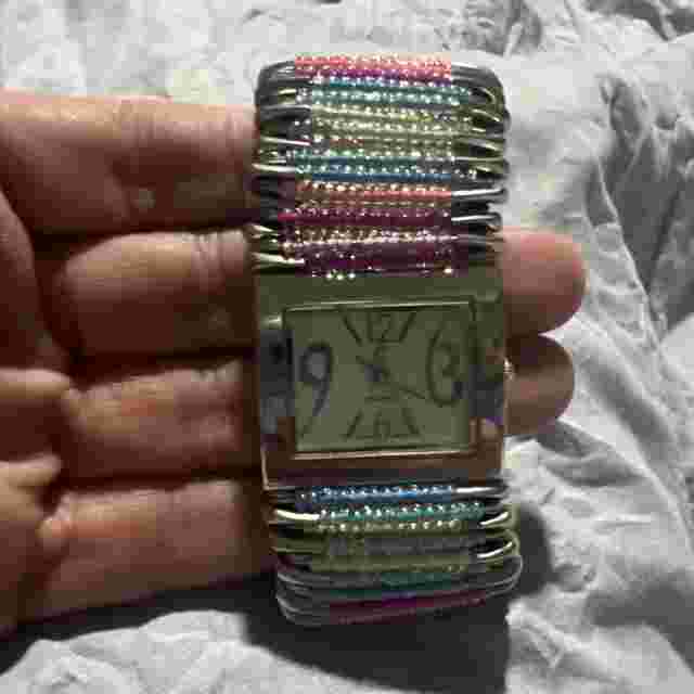 Ladies Multi Colored Elastic Safety Pin Watch, needs a battery.