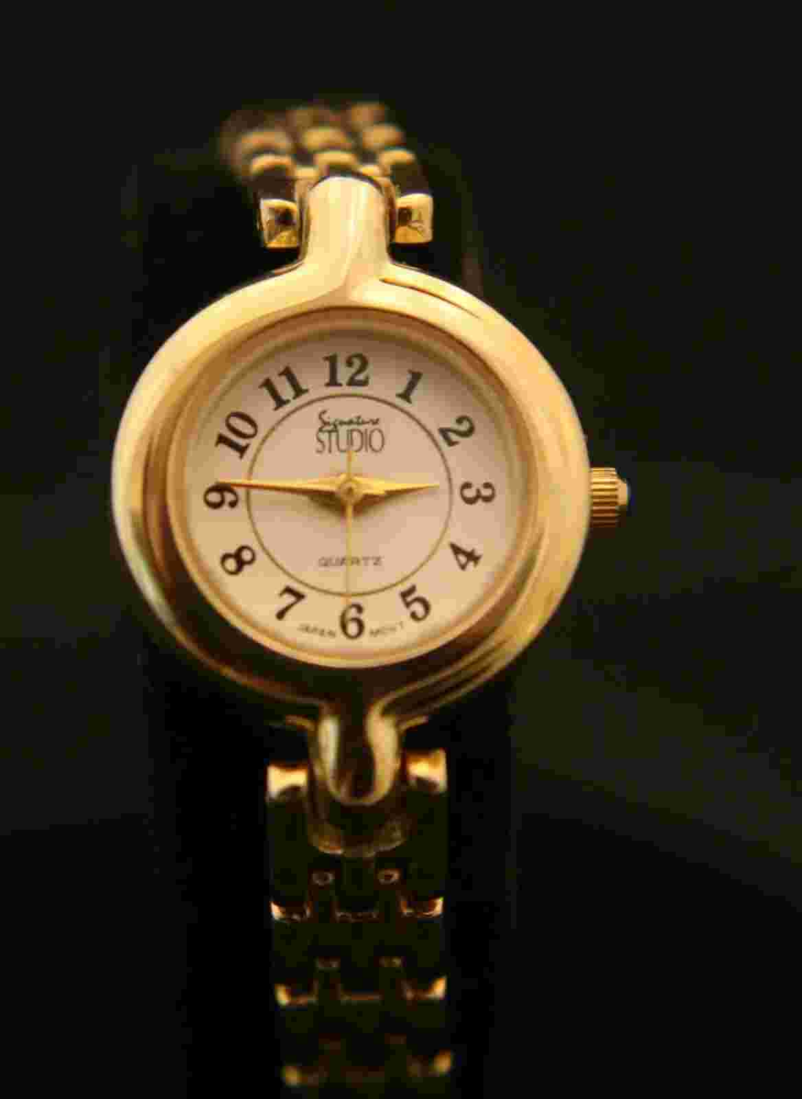 Stunning ladies Studio Signature gold dress, cabochon crown quartz wristwatch
