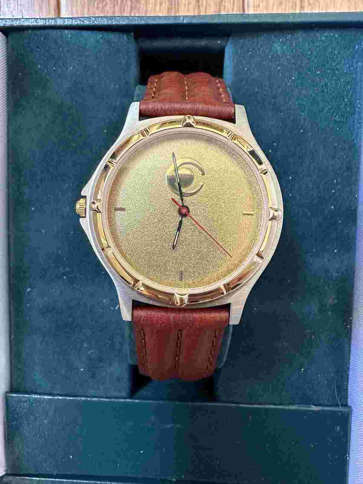 Jostens Watch with case. Needs new battery. Good condition. Leather wristband